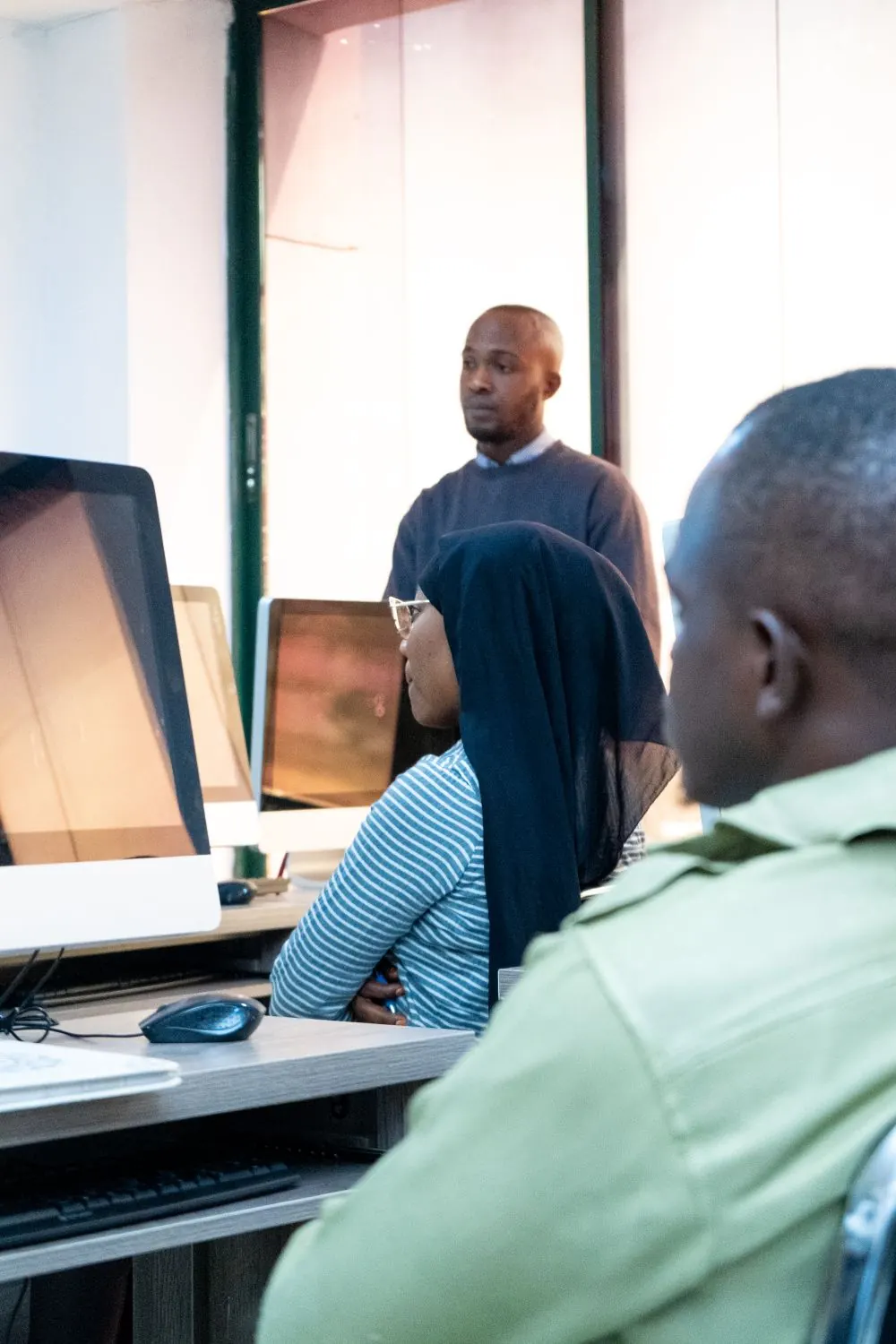 Students learning at computers in a digital skills classroom