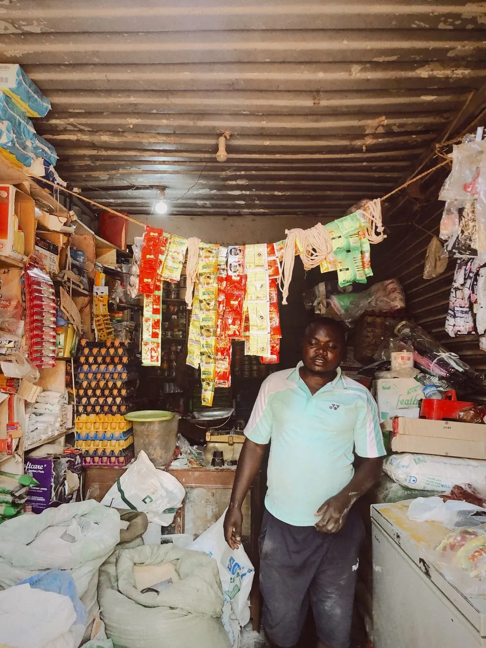 A small business owner standing inside their well-stocked shop